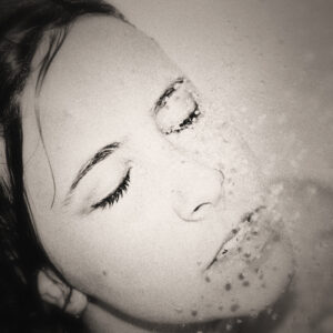 Picture of an adult woman's face under a shower spray. Source Pixabay.com.