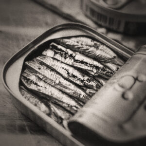 Picture of canned sardines with the cover partially bent back. Source Pixabay.com.