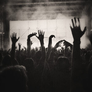 Picture of people crowded together with their hands in the air during a concert. Source Pixabay.com.