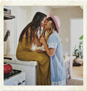 Picture of two women kissing, one is seated on the kitchen counter. Image by RODNAE Productions on Pexels.
