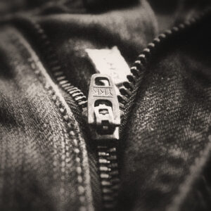 Picture of a zipper fitted on a pair of denim jeans. Source Pixabay.com.