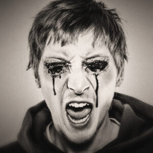 Picture of a man whose eyes are bleeding, and appears to be screaming in pain. Source Pixabay.com.
