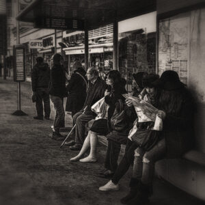 Picture of a busy bus stop, patiently waiting for their bus. Source Pixabay.com.