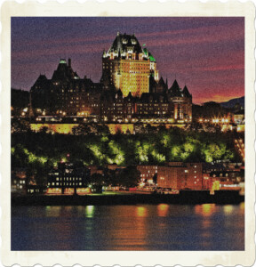 Picture of the Quebec City skyline taking at night from the water. Features Chateau Frontenac prominently above the palisades. 