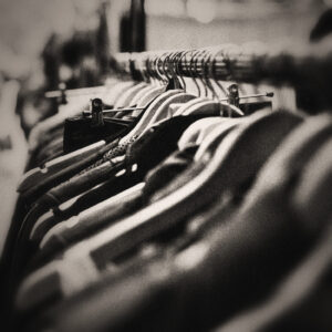 Image of clothes on a rack of hangars. Source Pixabay.com.