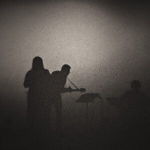 Image of silhouettes from a band on a stage. Image by iloarca from Pixabay.com.