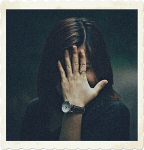 Picture of an embarrassed woman who is hiding her face with her hand. Image by MIXU on Pexels.
