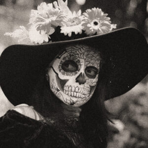 Image of a woman in black with skull makeup. Source Pixabay.com.