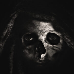 Picture of a hooded woman with a skull superimposed. Source Pixabay.com.