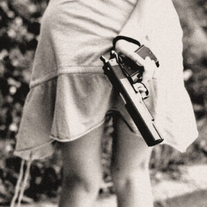 Girl concealing a pistol behind her back. Source Pixabay.com.