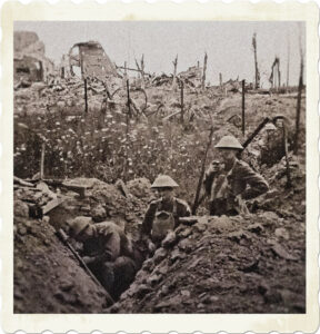 Picture of soliders from the Great War in a trench with a ruined city in the background. Image by Bruce Mewett from Pixabay.