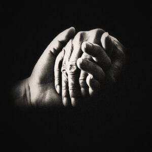 Black and white picture focused on hand holding with no other detail. Source Pixabay.com.