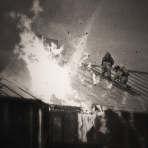 Image of two firefighters on a roof of a burning building. Image by David Mark from Pixabay.com.