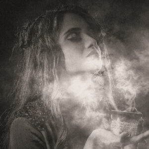 Woman smelling wafting perfume or smoke. Source, pixabay.com.