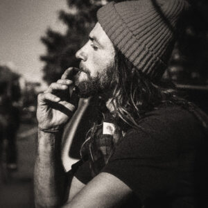 Picture of a bearded man wearing a beanie hat smoking week. Source Pixabay.com.