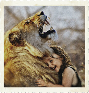 Picture of a smiling girl with curly hair hiding a lioness that appears to be roaring. Image by Sarah Richter from Pixabay.