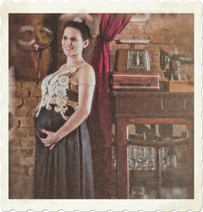 Picture of a pregnant woman in what appears to be an antique shop. Image by Vidallari from Pixabay.