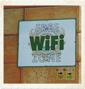 A sign posted on brick wall stating that this is a 'Free WiFi Zone.' Image by FotoFanni from Pixabay