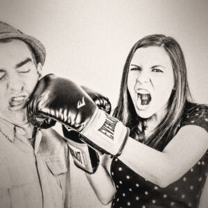 Picture of a woman with boxing gloves punching out a man. Source Pixabay.com.