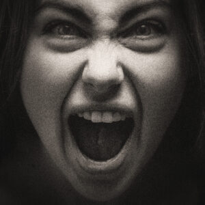 Picture of a woman's face while she screams. Source Pixabay.com.