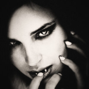 Picture of a woman with fangs, presumably a vampire. Source Pixabay.com.