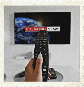 Picture of a hand holding a remote, with a television in the background that reads 'Breaking News.' Image by Tumisu from Pixabay.