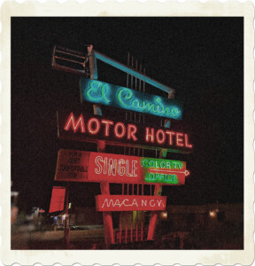 Picture of the Hotel sign for the 'El Camino Motor Hotel' shining brightly in the night sky. Picture by Allen from Pexels.