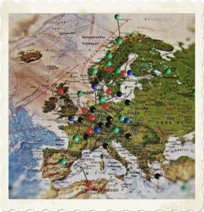 Picture of a map covered in multi-coloured pins. Image by ASSY from Pixabay.