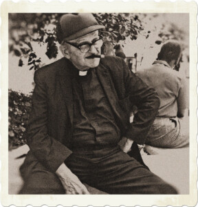 Picture of an old catholic priest with thick glasses wearing a baseball cap, and smoking a cigar. Image by David Henry from Pexels.