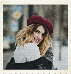 Picture of a blonde wearing a purple beret, with her fur line coat below her shoulders, and snow covering the ground. Image by EVG Kowalievska from Pexels.