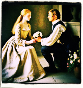 His eyes flowed over the blonde's pale skin of her legs, arms and shoulders and marvelled at her beauty. There was a scent permeating the air, although he was not certain if she was the source or the flowers. Located in a simple bedroom. Clothes and scene appropriate to the 16th Century France.