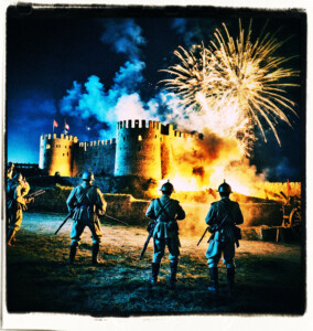 Soldiers blowing up a fortification at night with fireworks. Clothes and setting appropriate to 16th century France.
