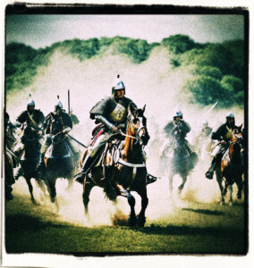 An European cavalry charge with swords drawn, hurtling down an open field. Clothes and style appropriate for 16th century France.