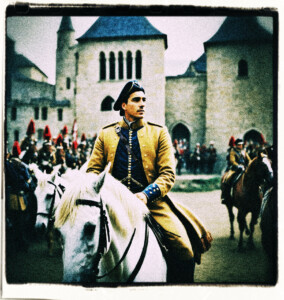 Man on a large horse, in uniform, departing from a garrison with marching soldiers in the background. Background and clothing appropriate to the 16th century France.