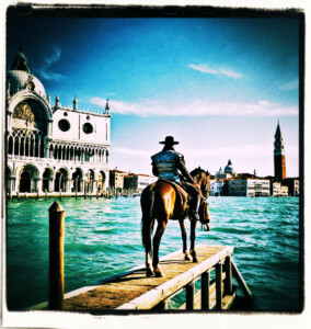 Man and his horse looking over Venice in the distance. Clothes and setting appropriate to 16th century Venice