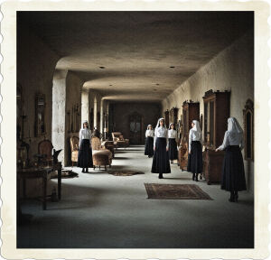 The space was linear and over 100m wide, which featured several smaller alcoves built into the walls. There was furniture, weapons, jewelry, and women's clothing everywhere. Everything a femme fatale needs for waging war on their enemy. Room has no natural source of light. Several women wearing uniforms looking like a nuns habit pop out in an ad-hoc way from out of the shadows.